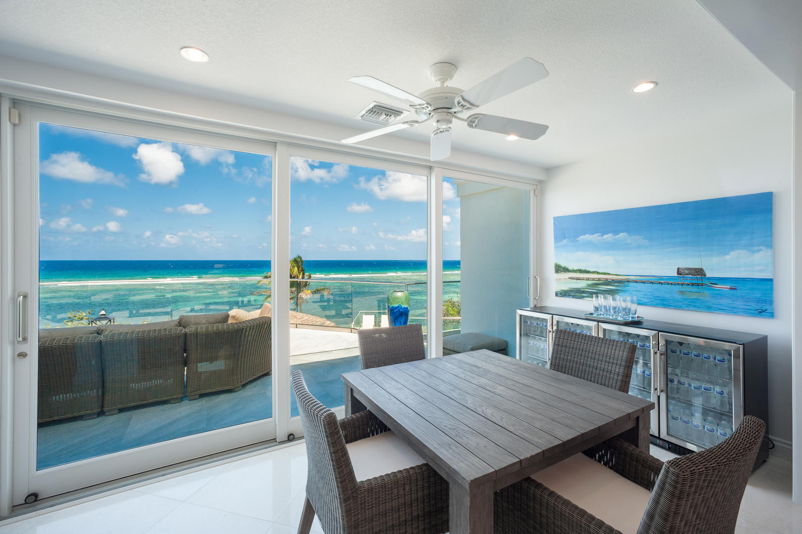 Sunroom Table and Beverage Fridges.