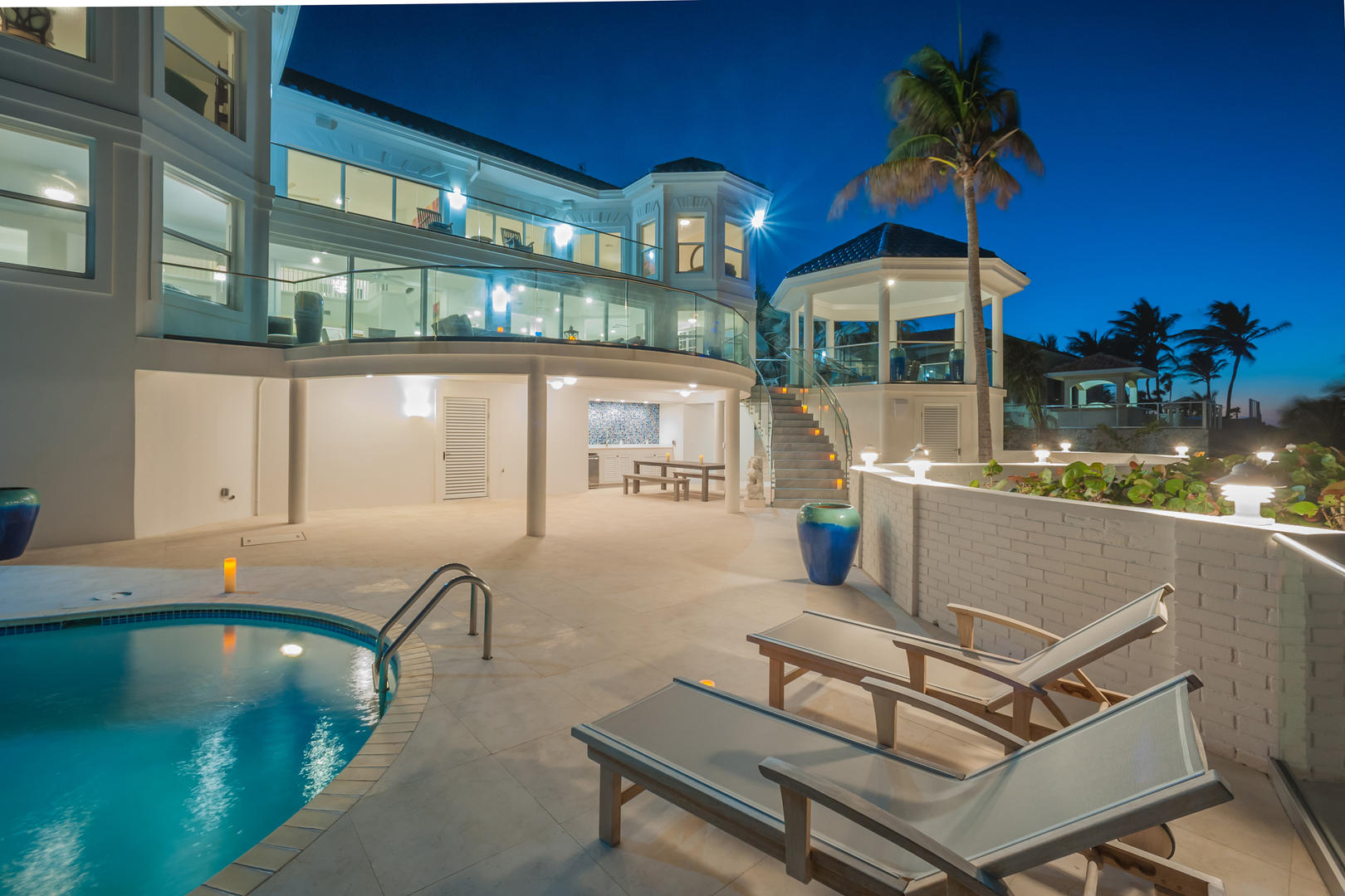 Lounge by your private pool with a stunning view of the Caribbean.