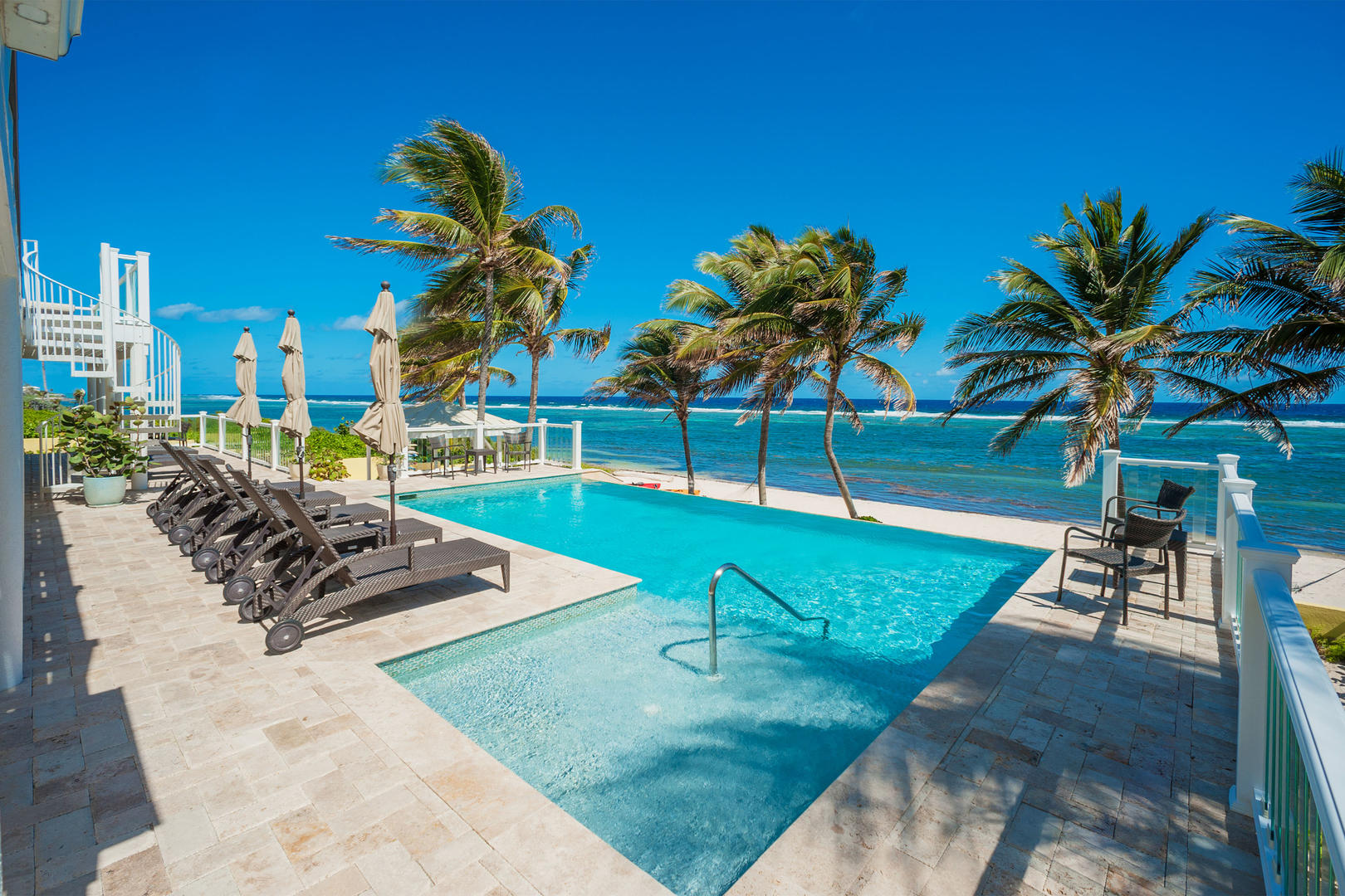 Relax and savor the panoramic views from the oceanfront pool.