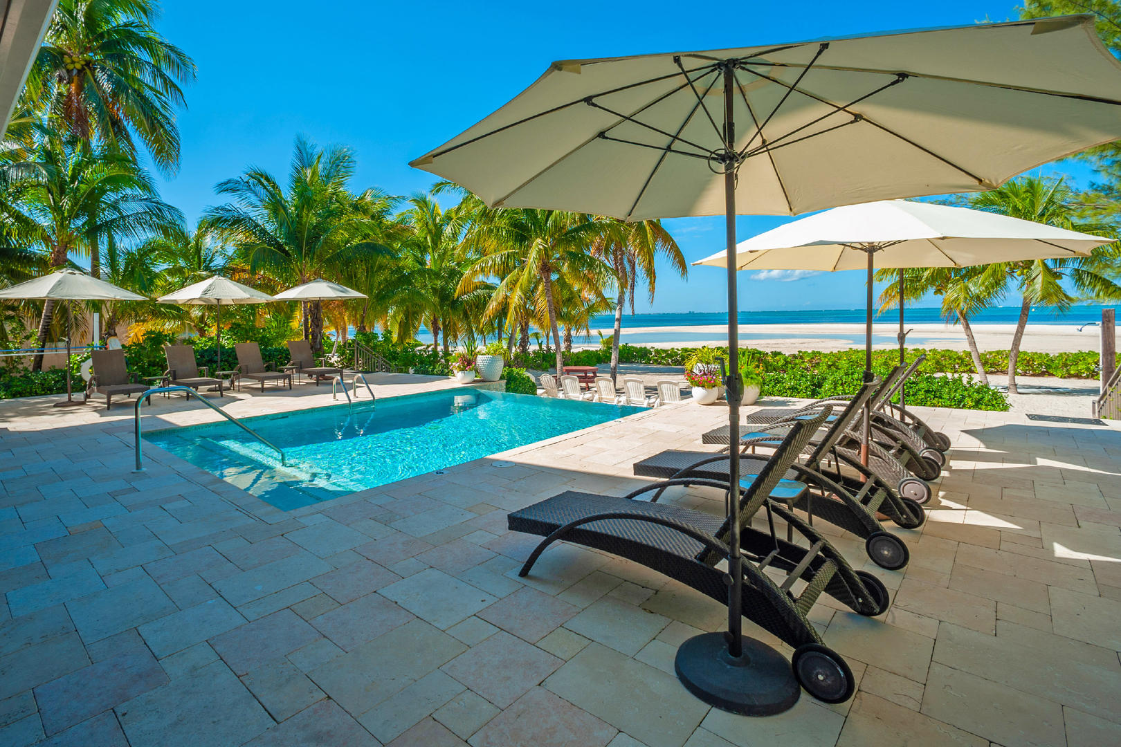 Lounge by your private pool with a stunning view of the Caribbean.