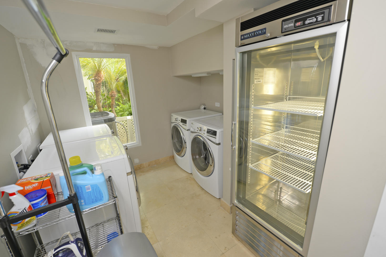 Laundry room with two washers and dryers.