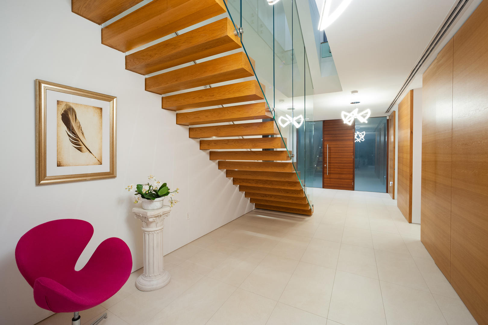 Foyer and floating stairs to upper level.	