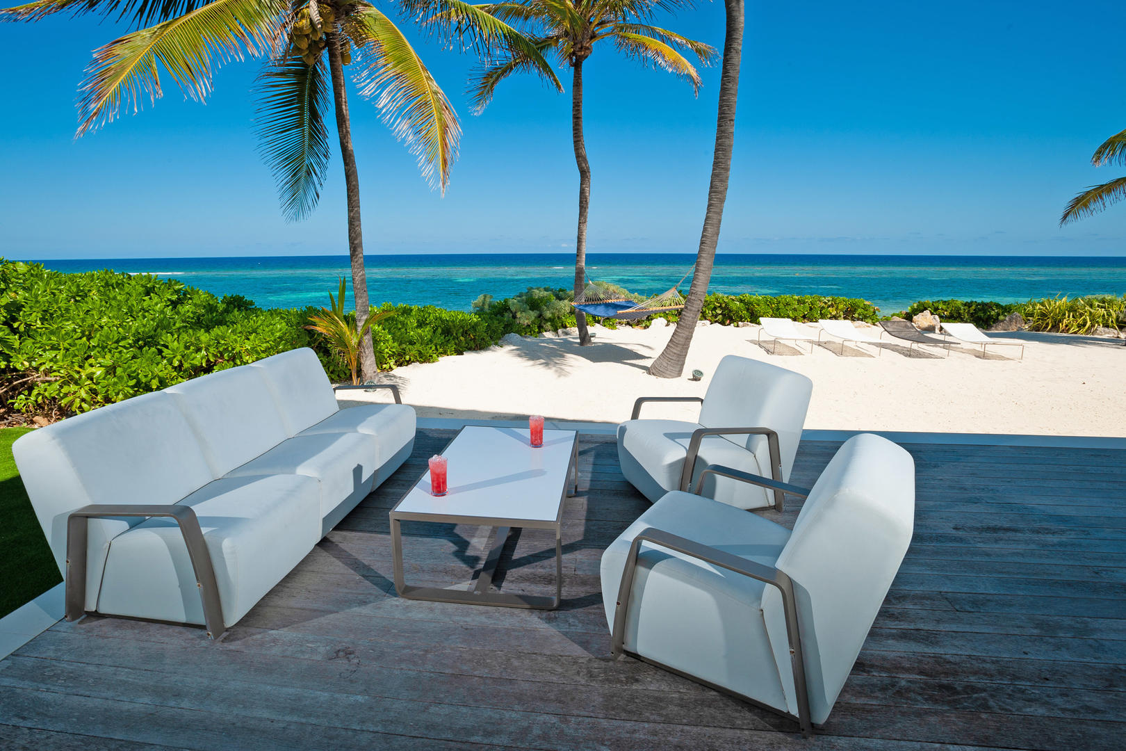 Pool deck sitting area with beach views.