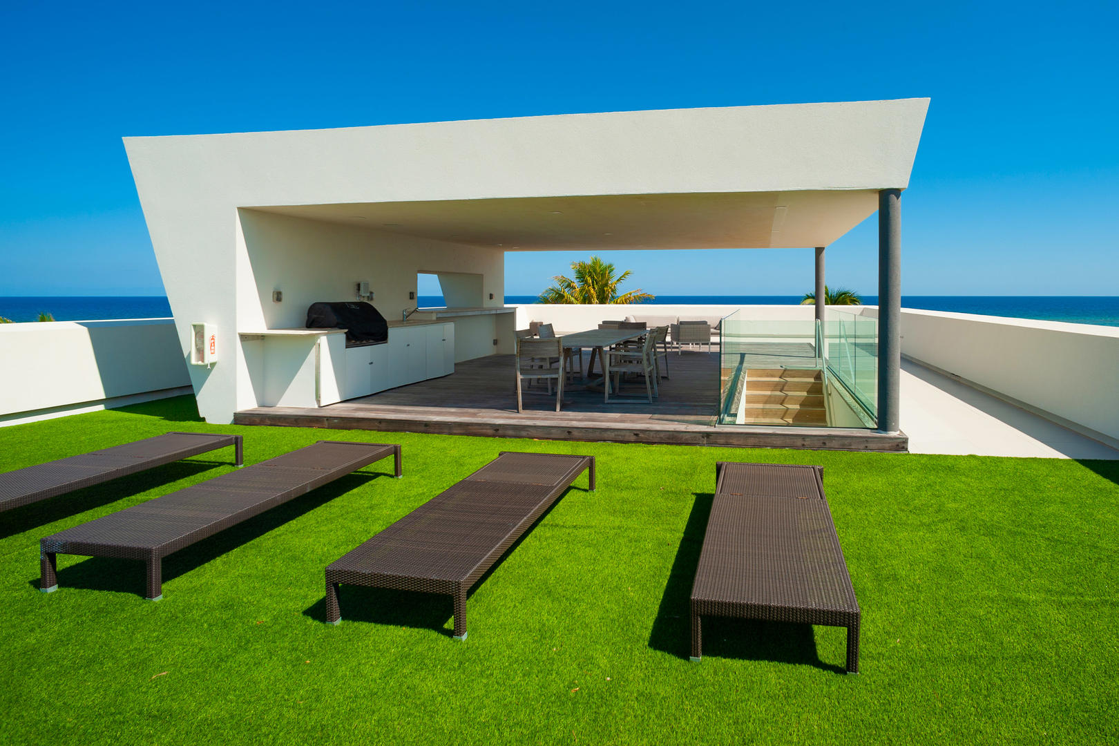 Rooftop sundeck with chaise loungers.