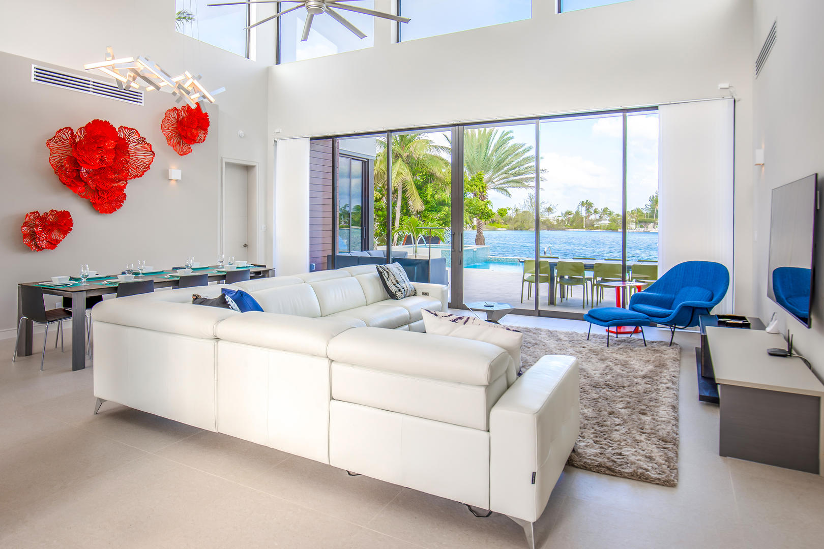Vaulted ceilings and sliding glass walls flood the home with natural light and scenic water views.