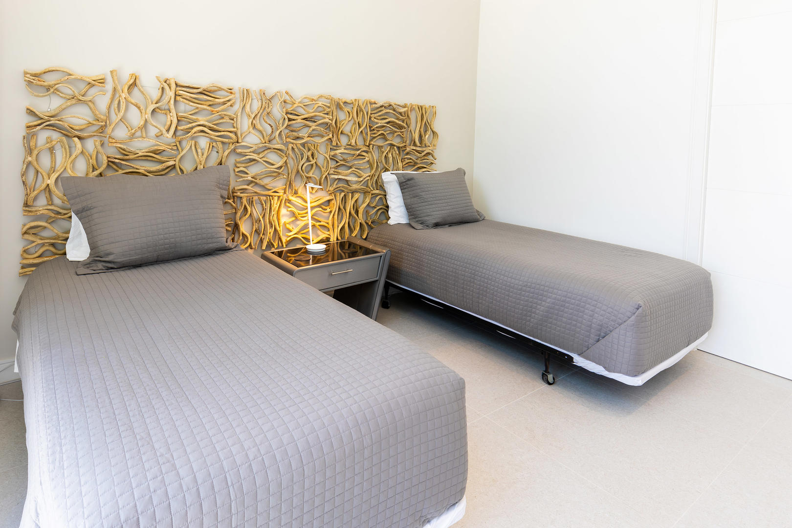 Twin guest suite sits toward the front of the villa. Twins can be converted to a king bed upon request.