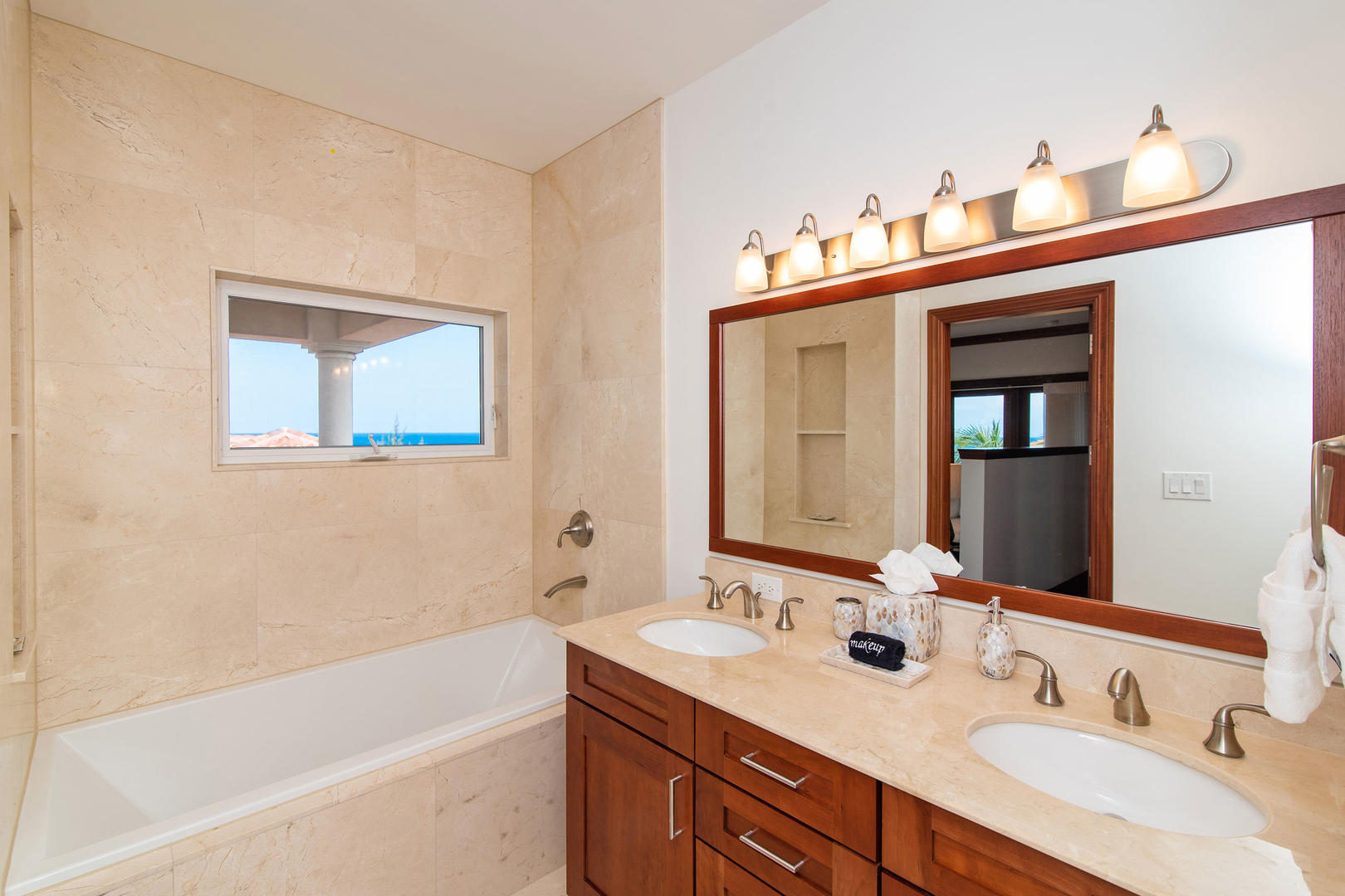 Master suite bath with double vanity, tub, and shower.