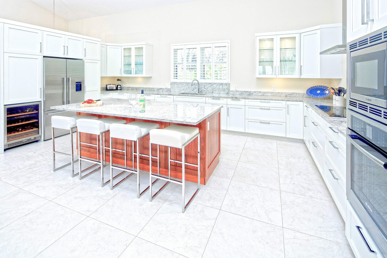 Sleek kitchen with modern appliances and a breakfast bar for four.