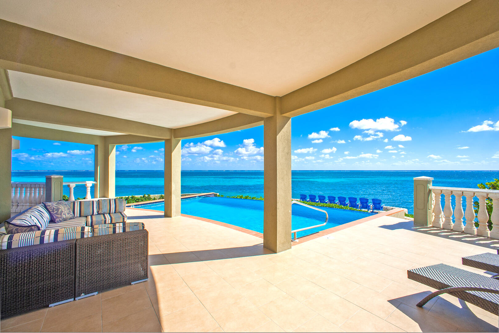 Lounge by your private pool with a stunning view of the Caribbean.