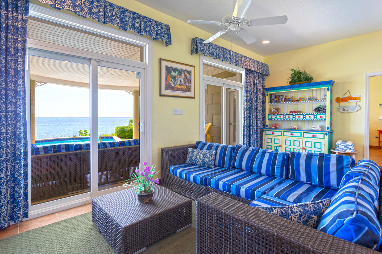 The guesthouse's living area with sectional sofa and ocean views.