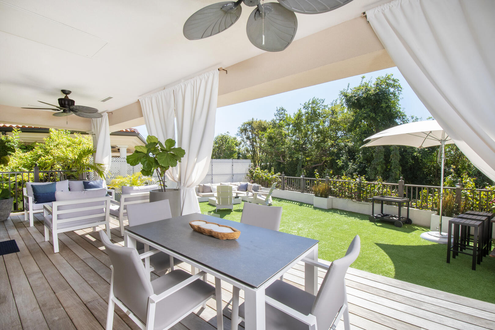 Veranda patio and a fenced backyard provides both sun and shade. 