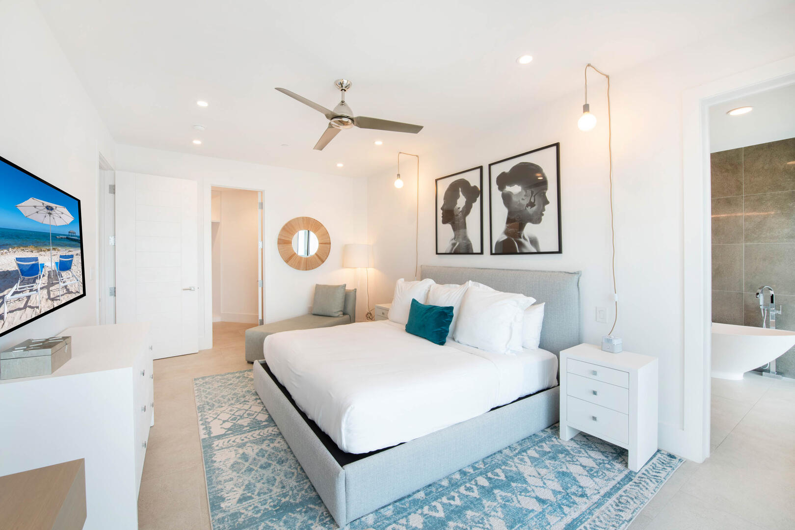 Primary Suite with ean views, walk-out access to a private open-air balcony, SmartTV, walk-in closet, desk   chair.