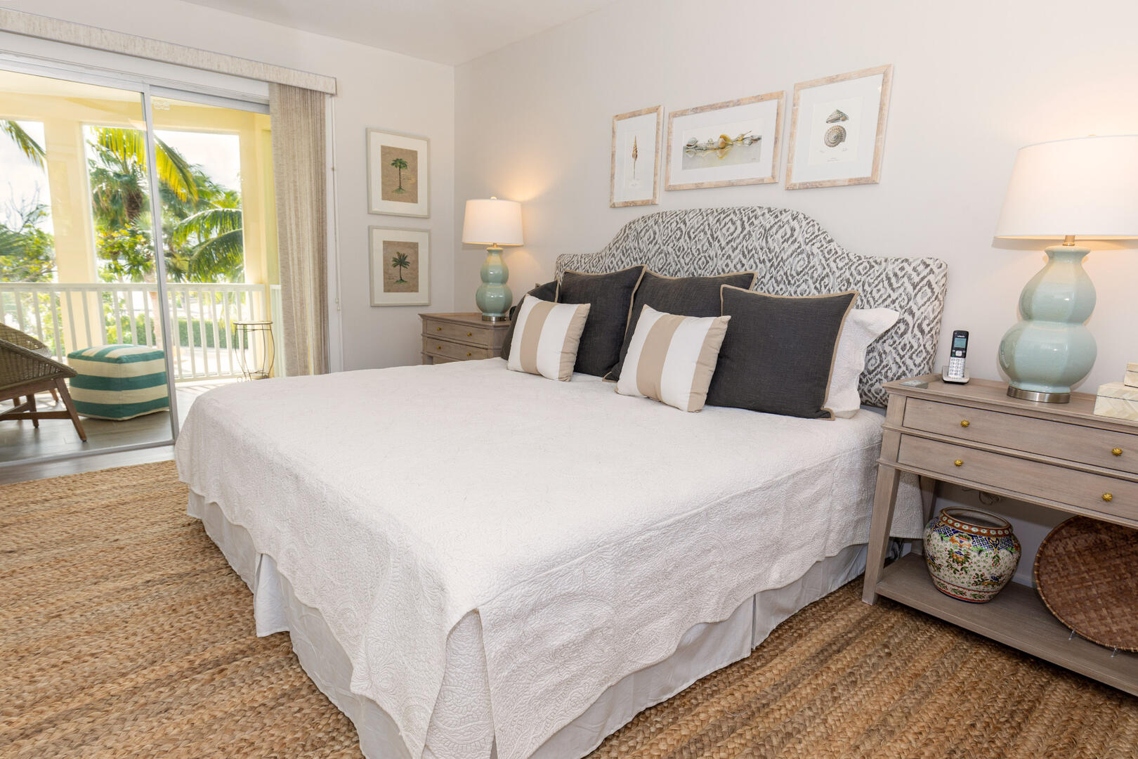 Primary Suite with king bed and walkout access to a private balcony.