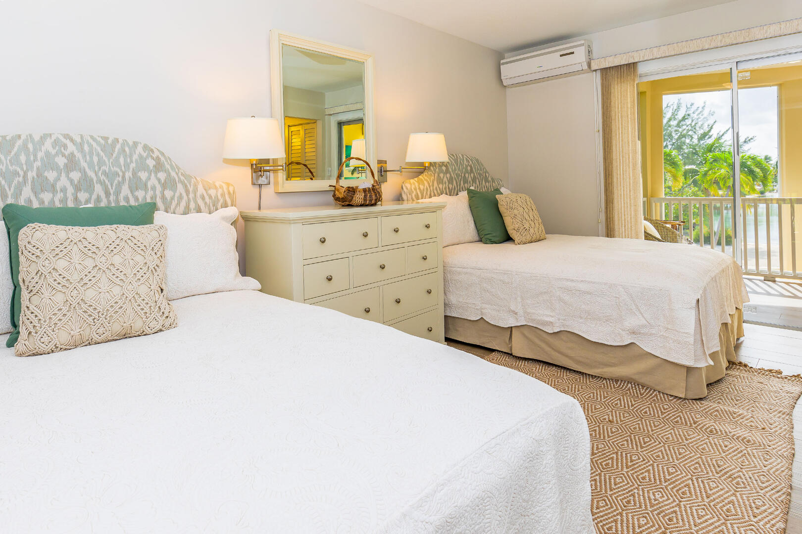 Guest Suite with two twin beds and private balcony in the background.