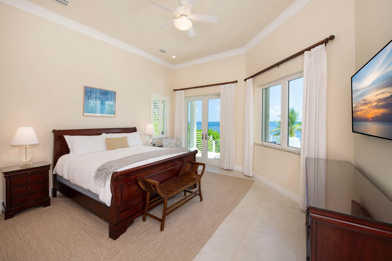 Guest Suite #1 is the primary suite with king bed, ocean views, television, and walkout access to the pool deck. 