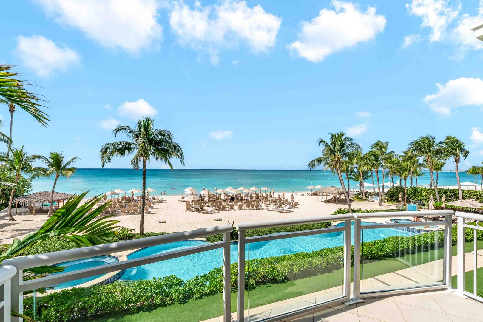 Balcony views of the resort's pool, hot tubs, and beach service. 