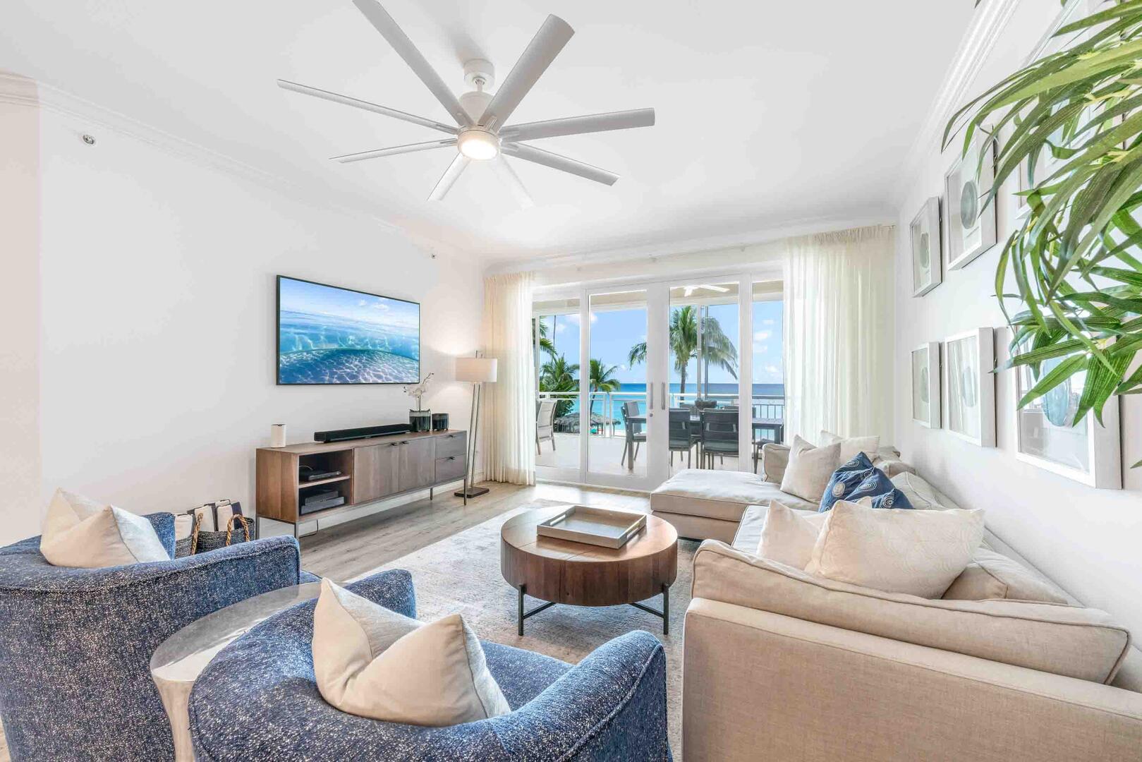 Living area with sofa seating, HD television with sound bar, plus walkout access to the ocean balcony. 