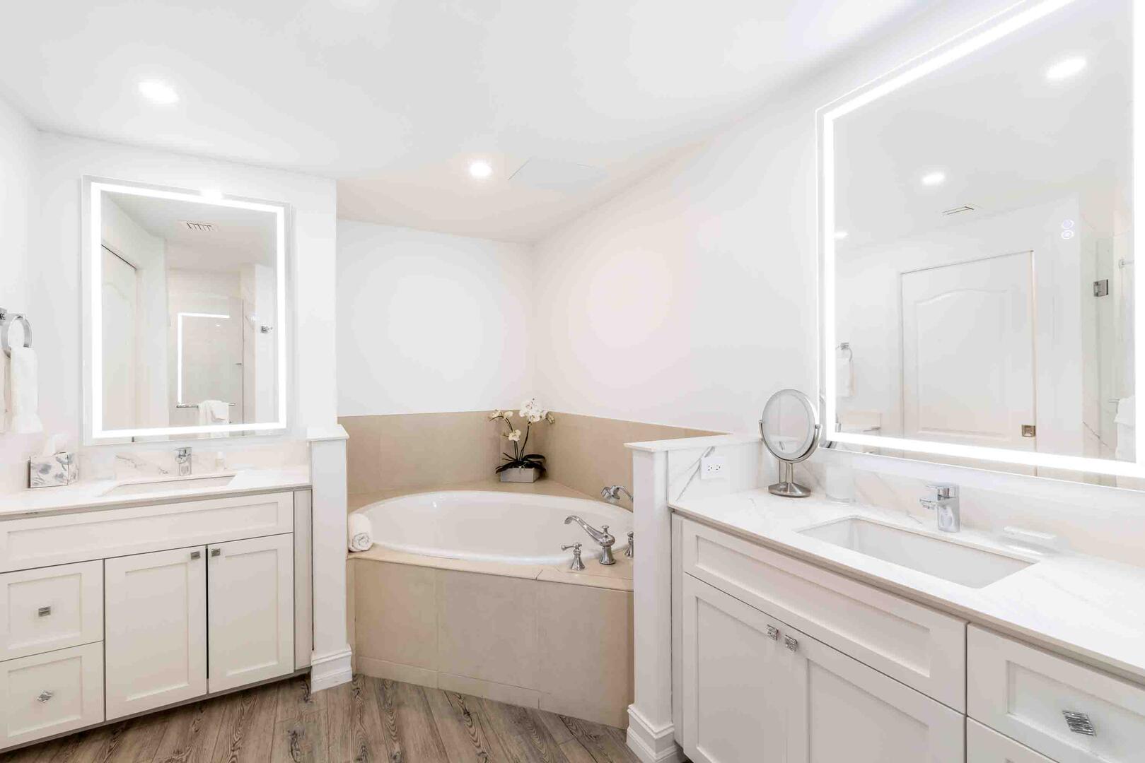 Primary Ensuite with dual vanities, soaking bathtub, and separate shower. 