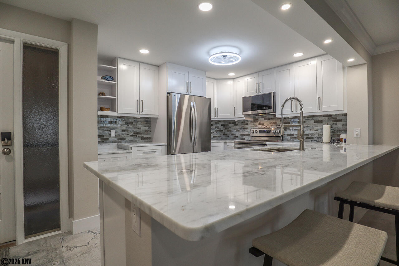 Gorgeous marble countertops, fabulous custom designed cabinets and backsplash and new appliances