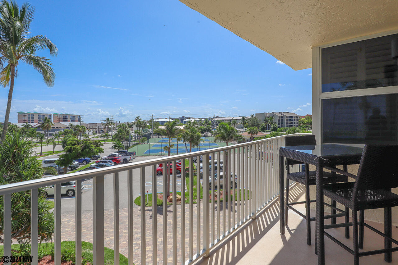 Front View of the Balcony is of the Tennis Courts, Pond and Boulevard 