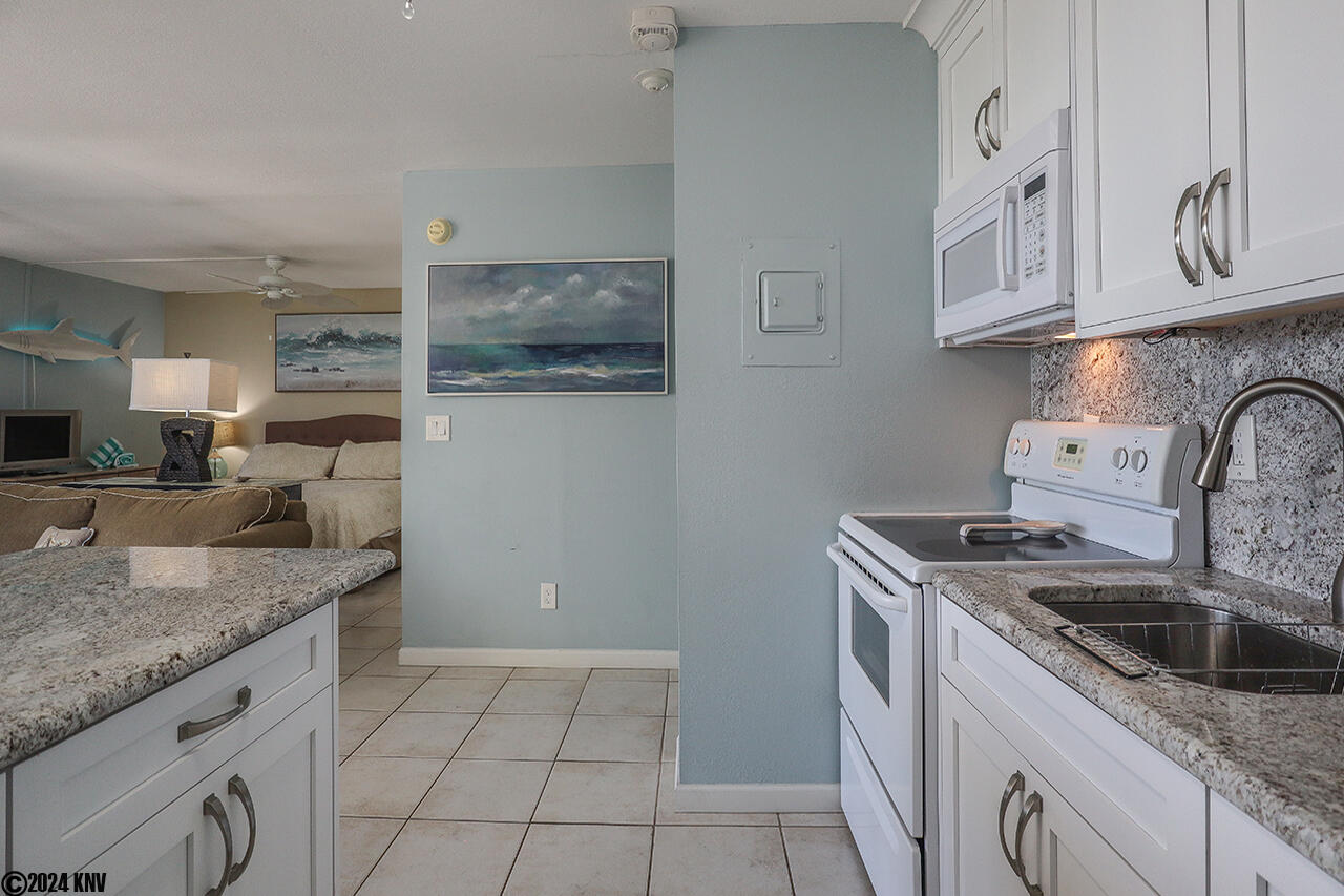 White cabinets, new appliances, and white granite counterops