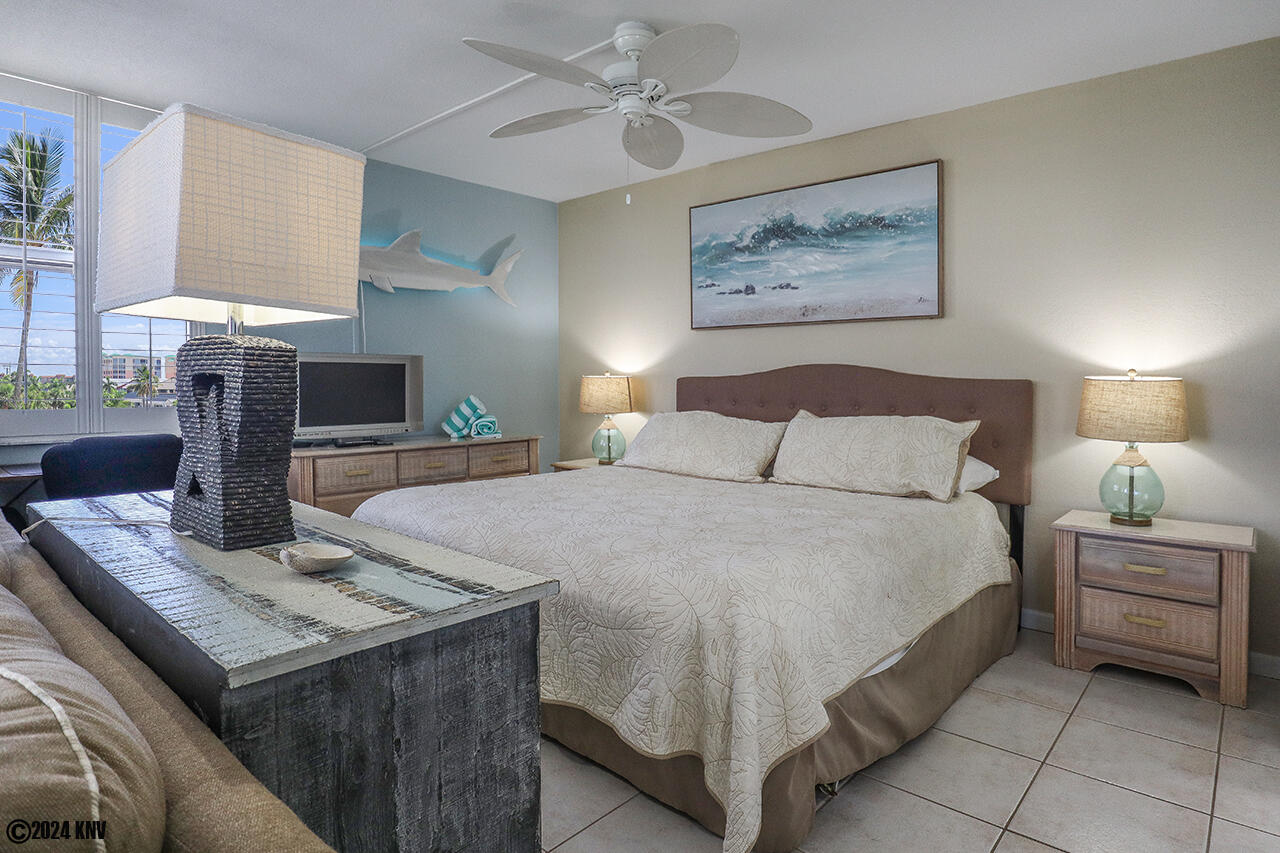 Fabulous Bedroom has a King Sized Bed dressed in fresh linens and a ceiling fan
