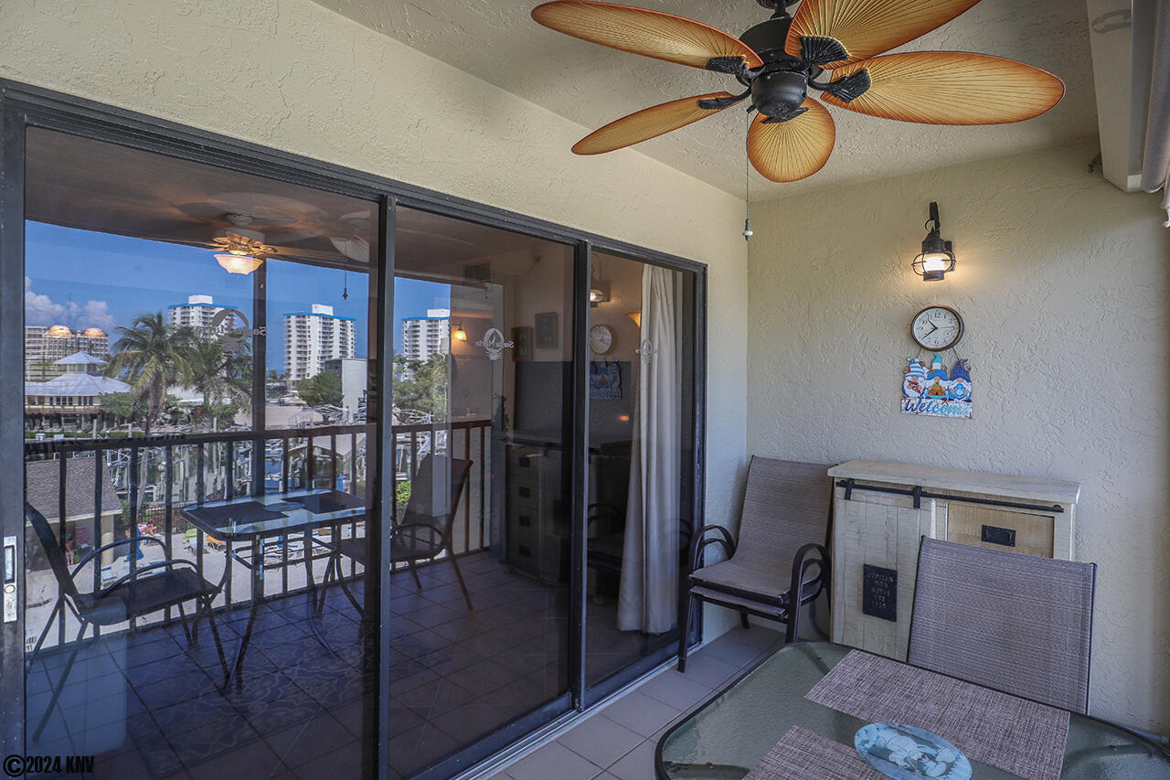 Screened In Lanai is outfitted with dining furniture and serving cabinet.