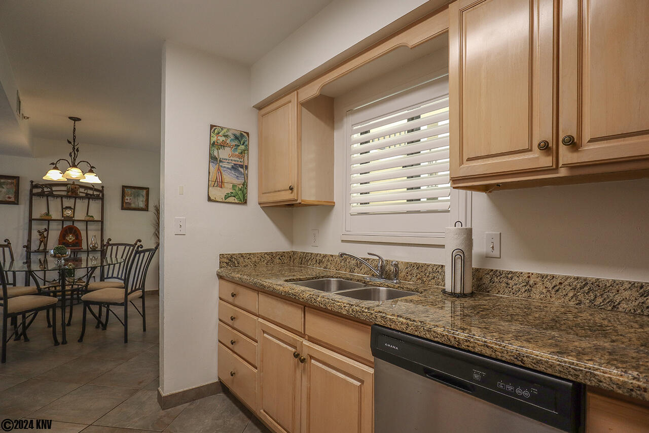 Kitchen has lots of countertop prep space and a dishwasher to assist in preparing meals