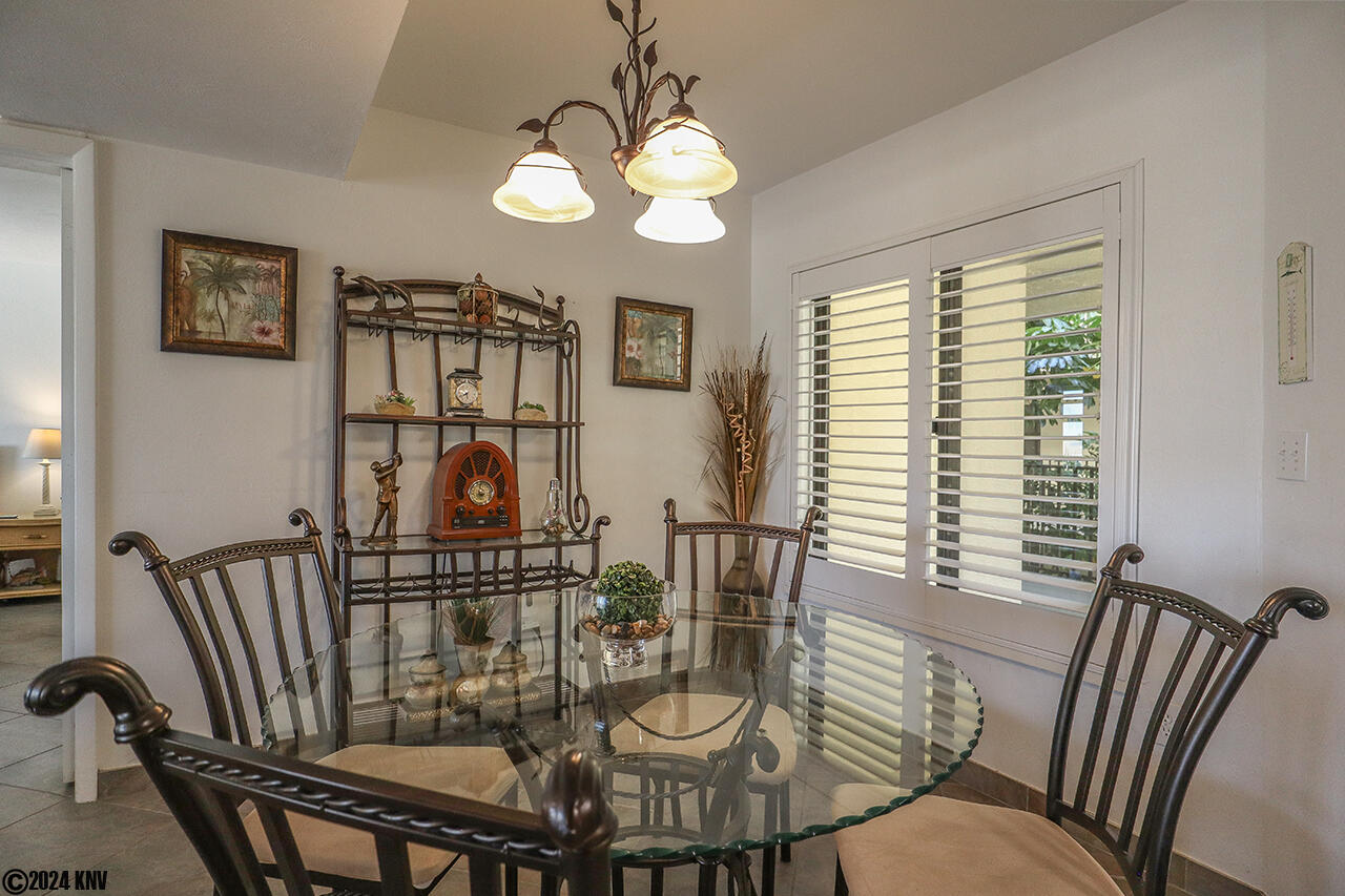 Decorated with a glass topped table and etagere