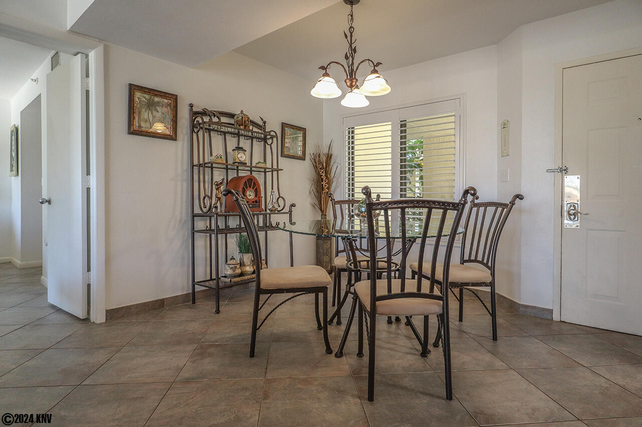 Dining area has a glass topped table for four