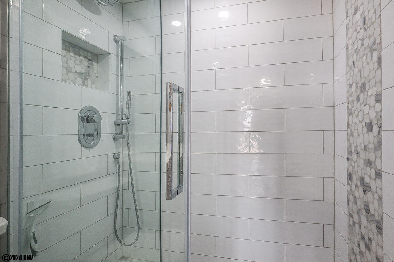 Guest Bath has beautifully tiled Walk In Shower