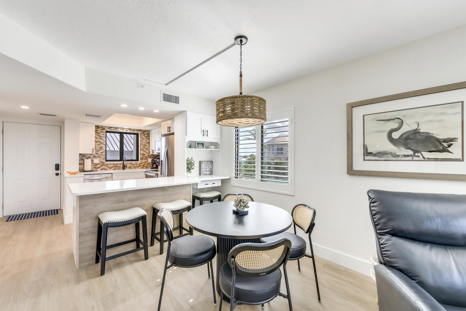 Beautifully designed space includes a breakfast bar with two seats and a desk area for working remotely, along with a table for 4 