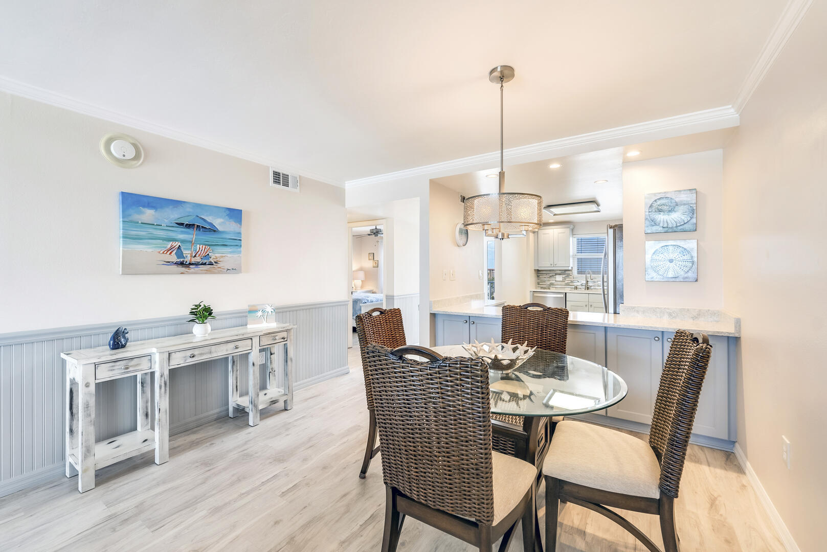 Dining Area has a lovely buffet and Glass topped Table for 4