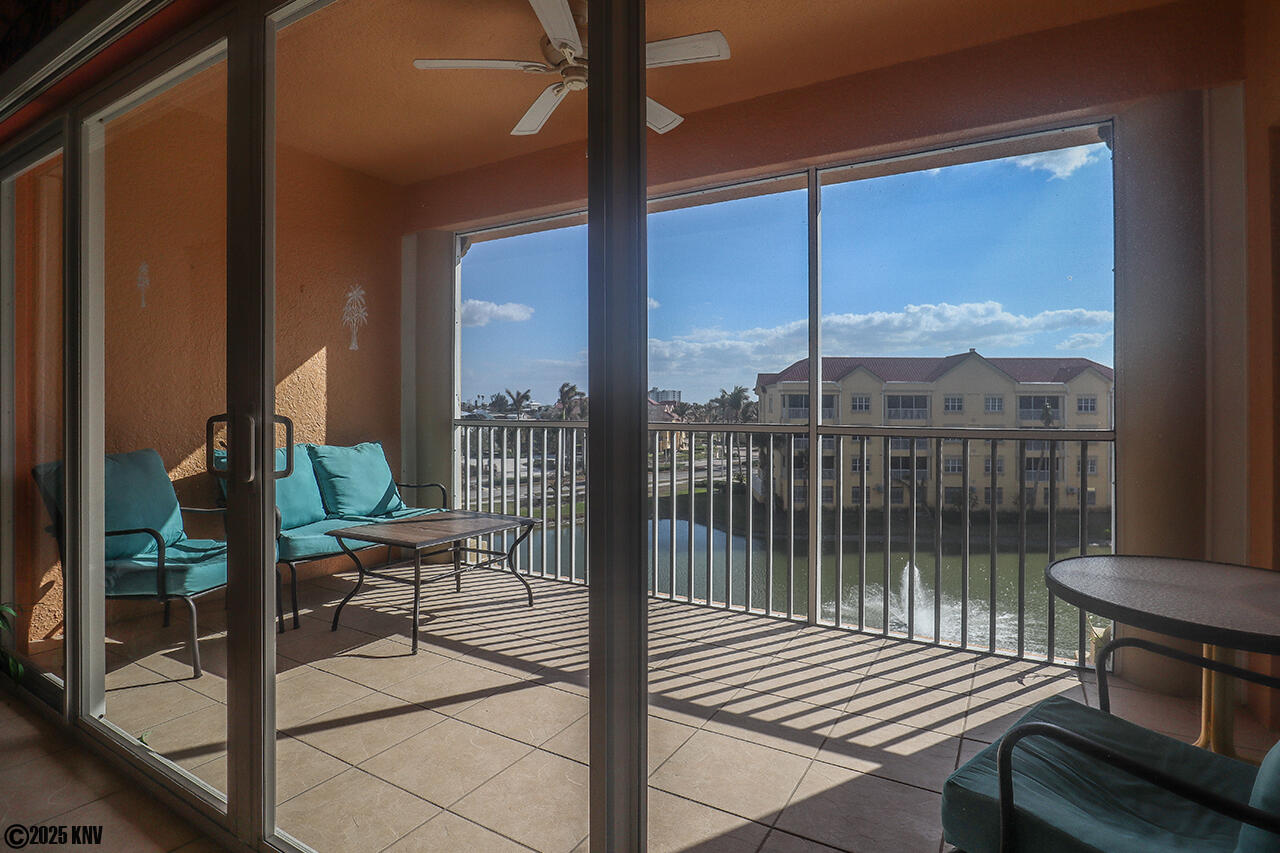 Huge Screened In Lanai has a view of the Bella Lago spring lake, the pool and the Gulf across the street
