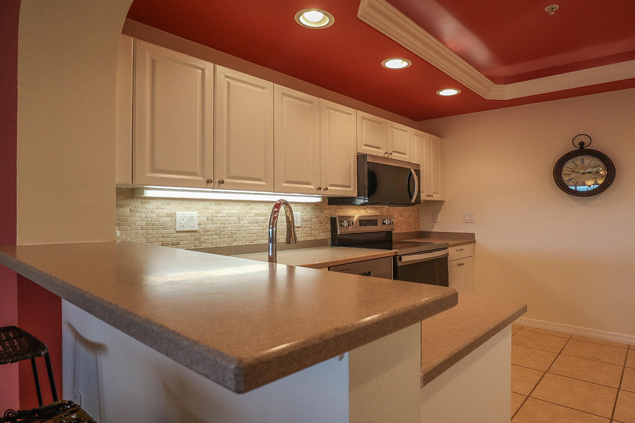 Large Kitchen enjoys corian countertops, new appliances and comes fully equipped with cookware and tableware
