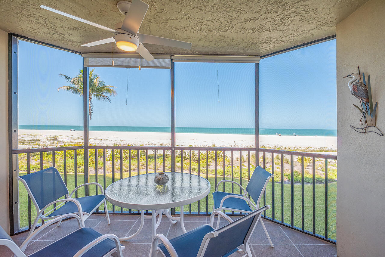 Unwind on your private Screened In Lanai with outdoor seating, ceiling fan, panoramic view of the Gulf and sea breezes flowing through.