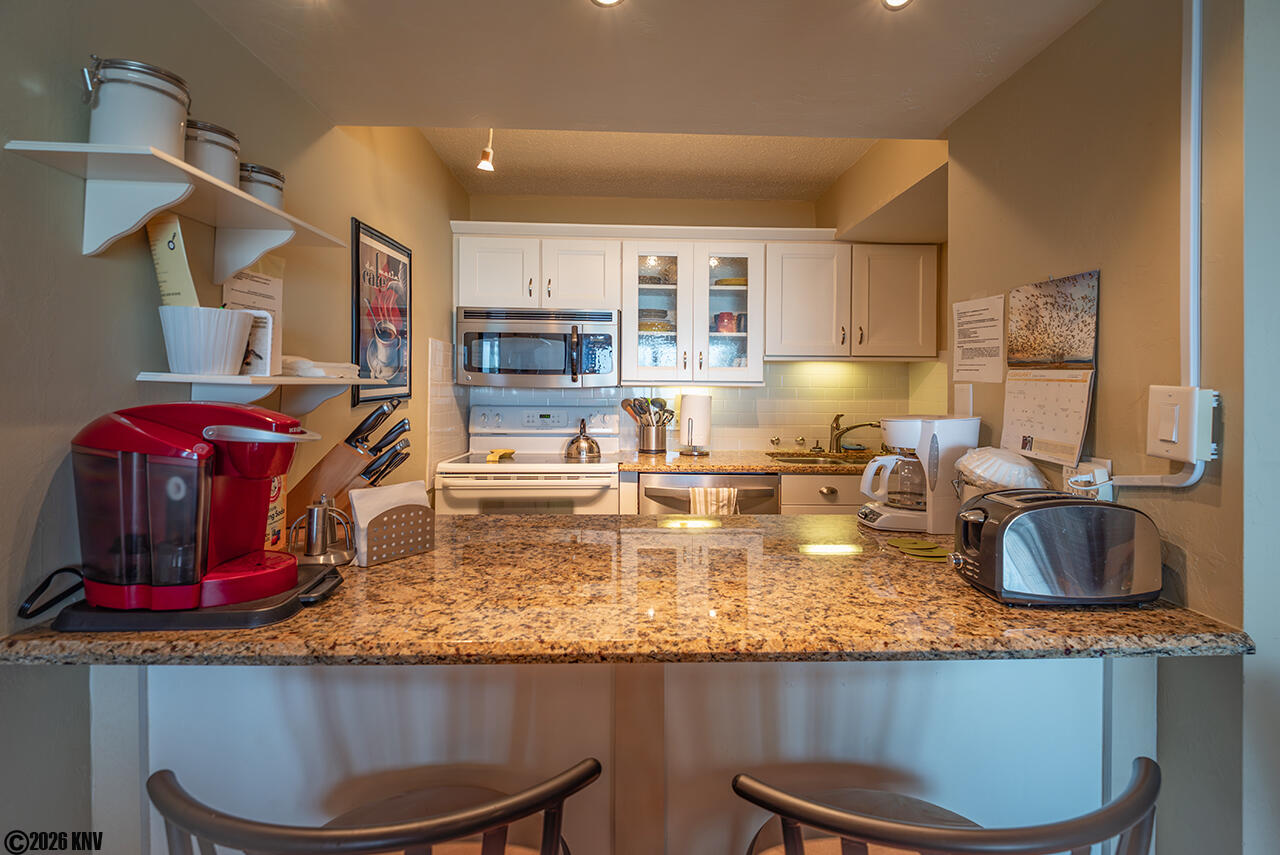 Kitchen has a breakfast bar for two