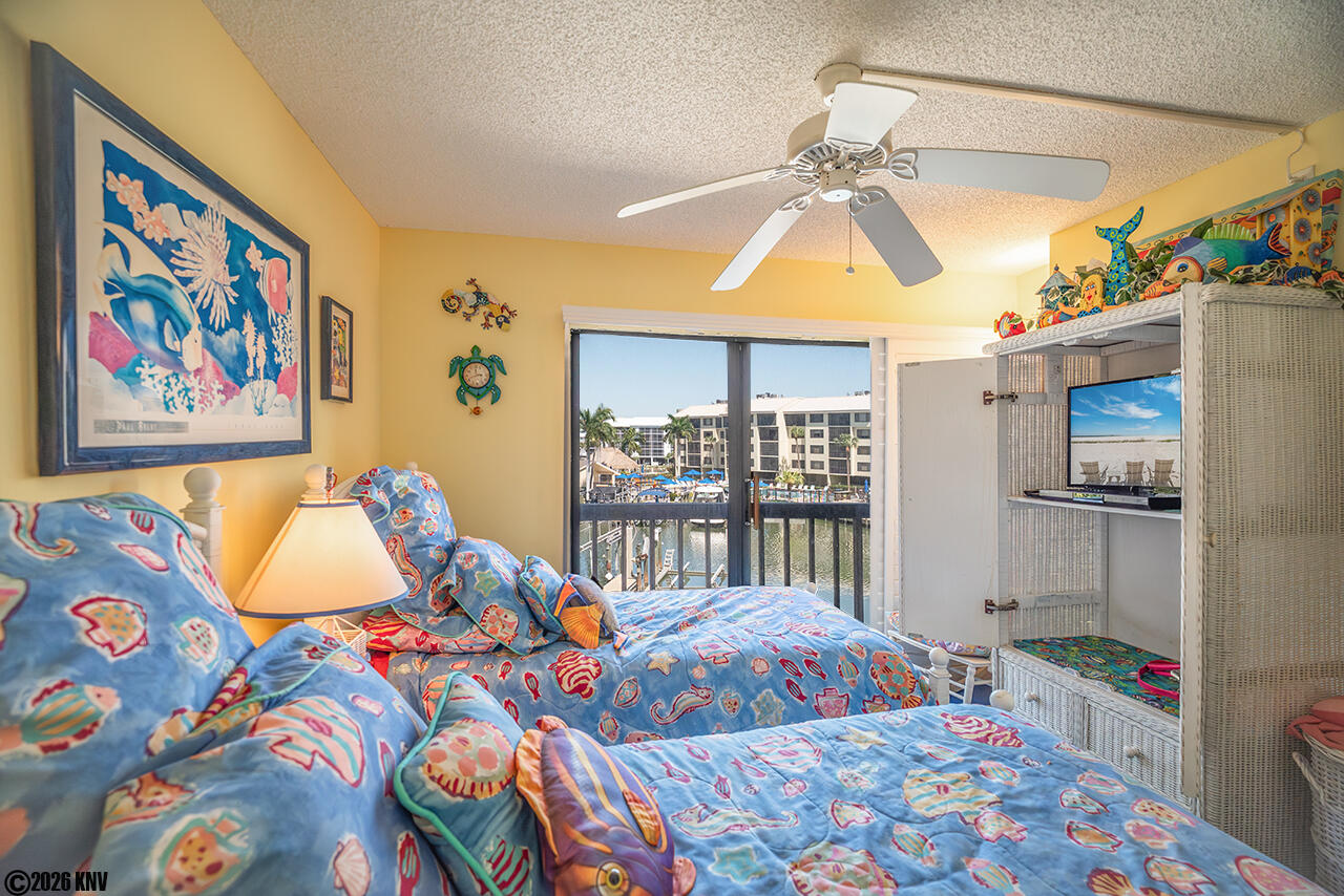 Guest Bedroom has Two Twin Beds, a view of the water and its own TV