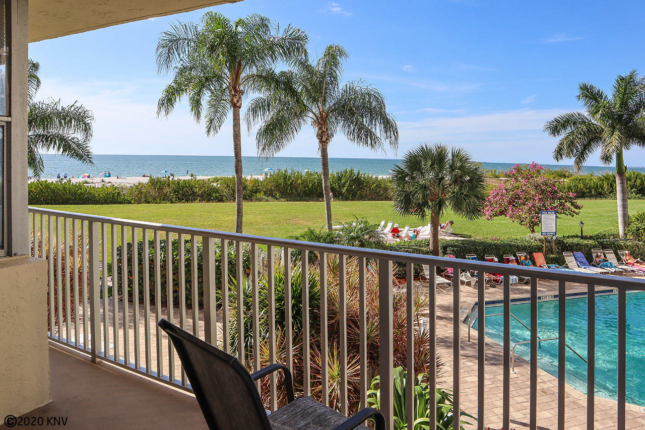 Sit out on your balcony that overlooks the pool and the beachfront