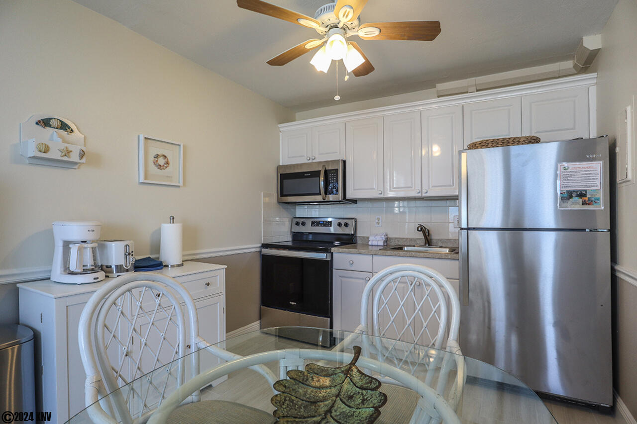 Full Kitchen has sink, full sized fridge and stove with oven