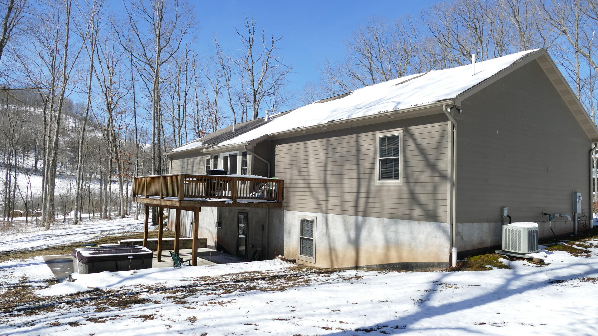 rear of house. winter. hot tub