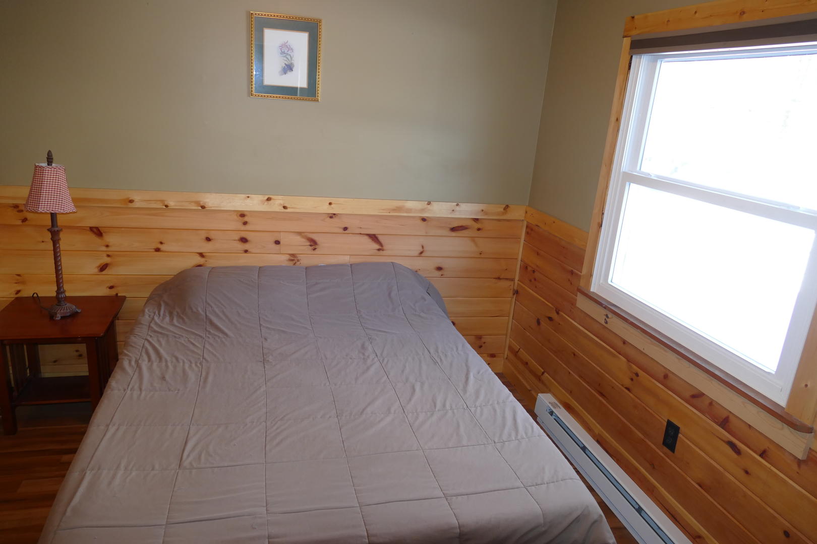 Main level bedroom with a queen bed