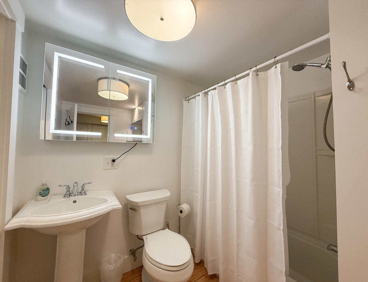 Hall Bath/Laundry Room with a Shower Tub Combo, Lower Level