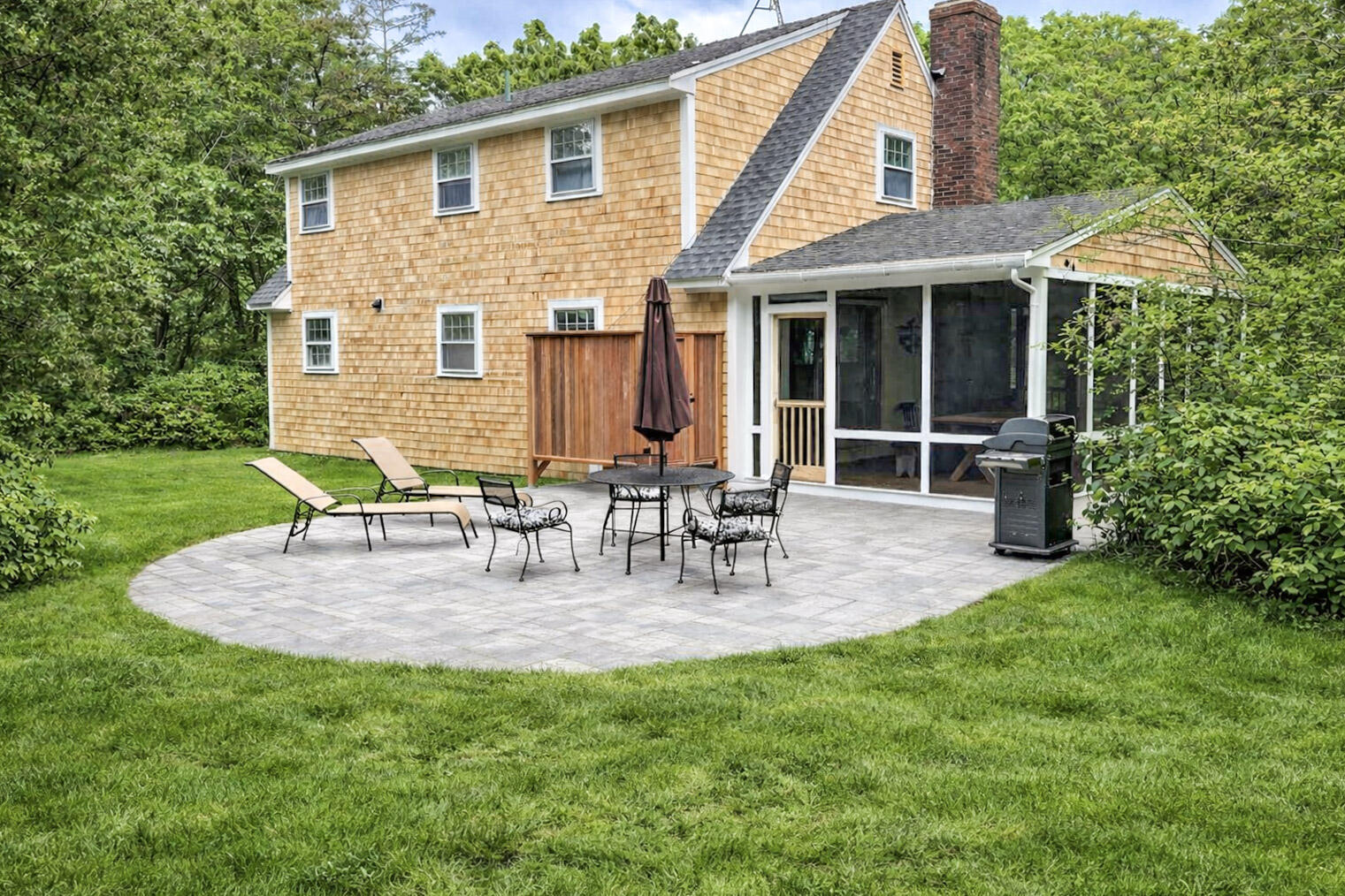 Outdoor dining and gathering space beside the home