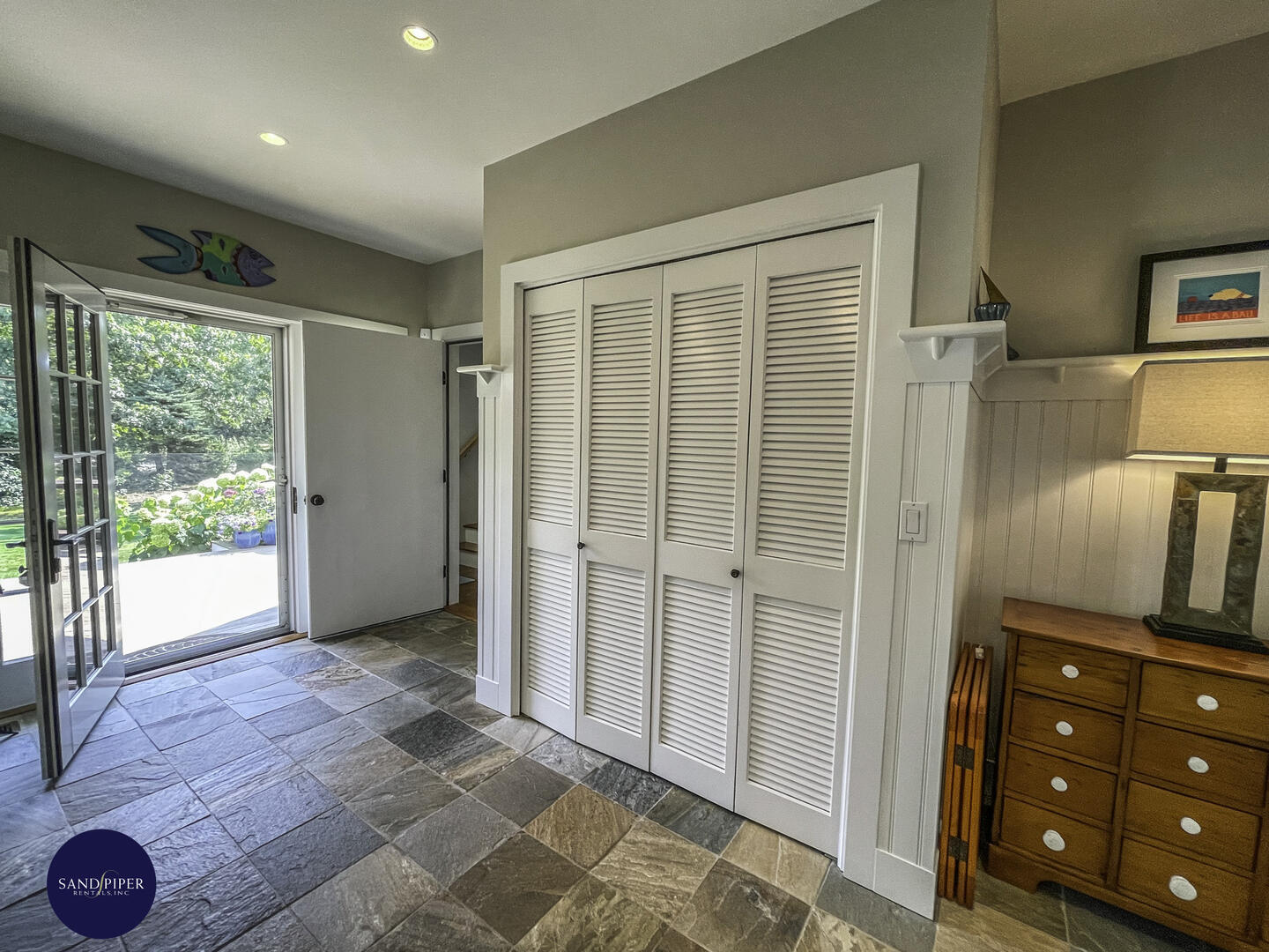 Mudroom with access to rear deck and BR4